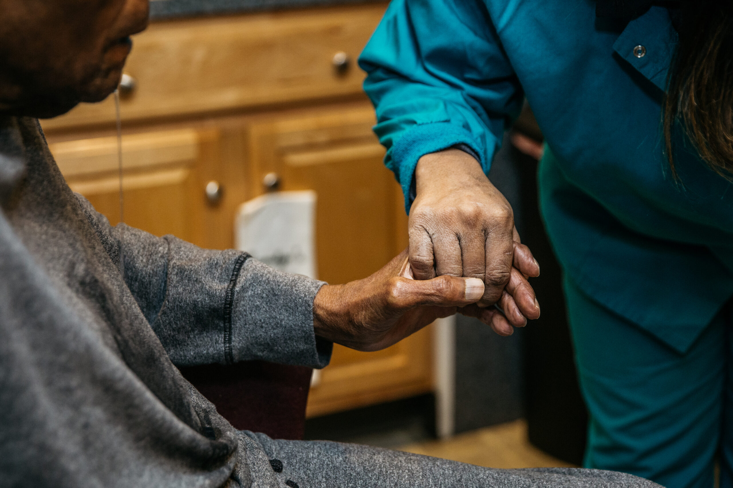 Provider and patient holding hands